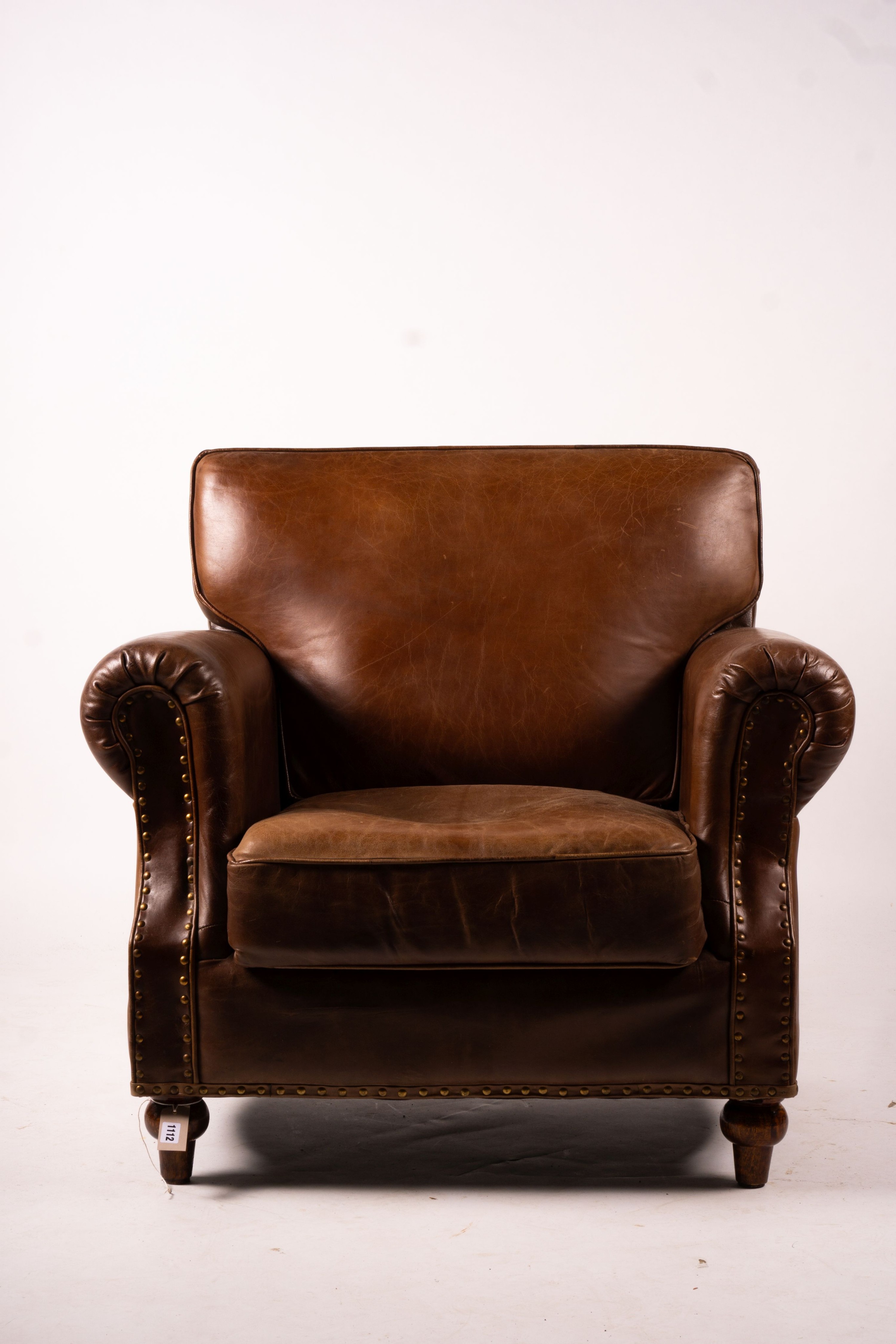 A pair of brown leather club armchairs, width 96cm, depth 80cm, height 90cm